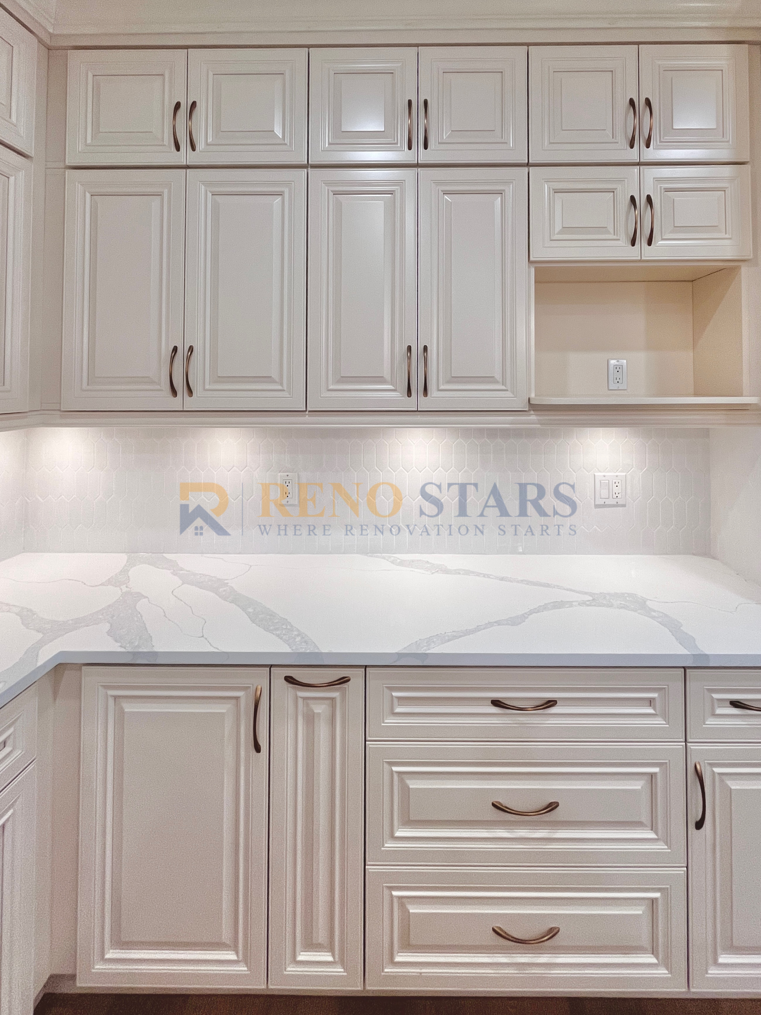 Modern kitchen cabinetry with elegant white finish and marble countertop.