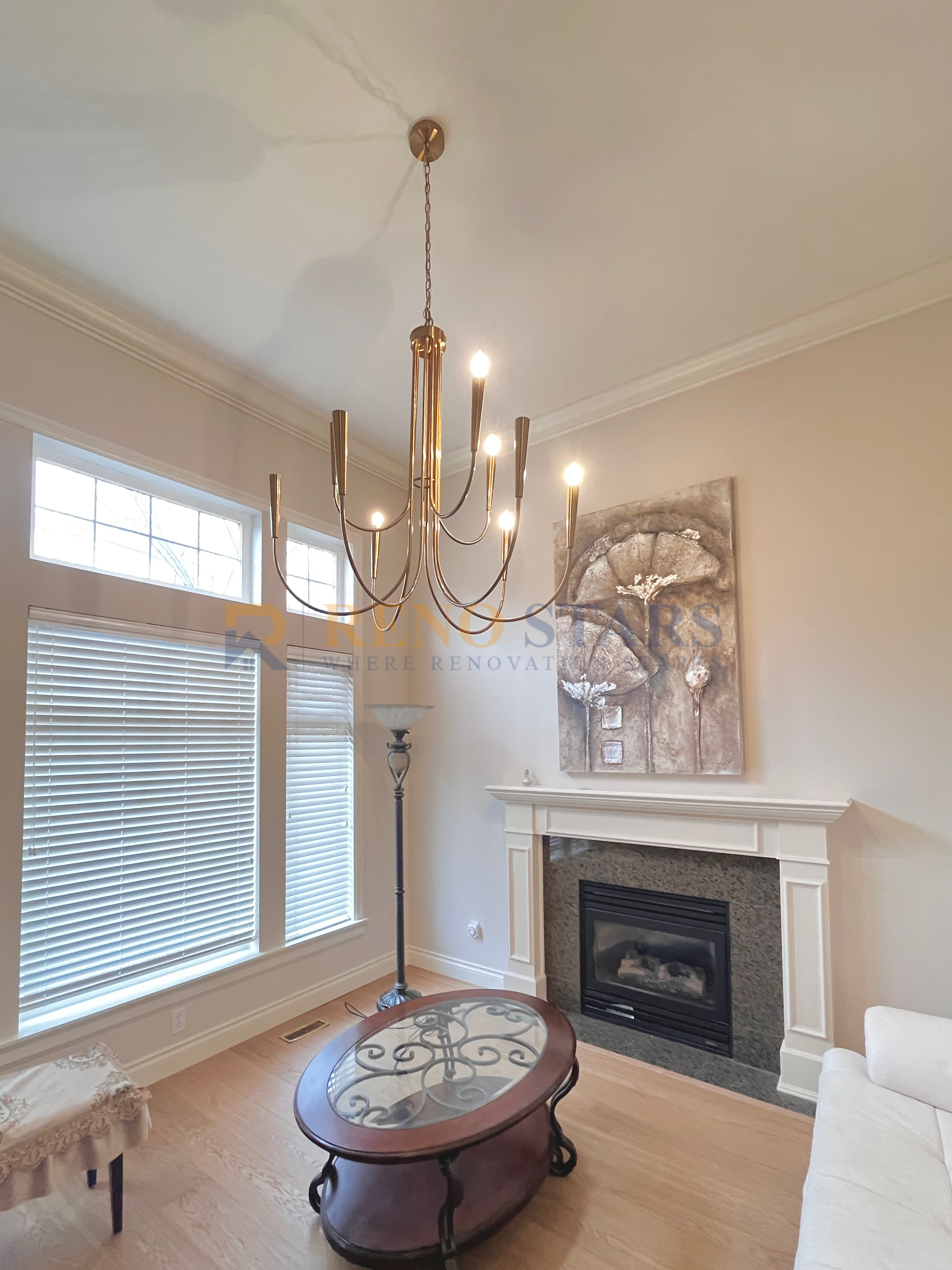 Modern living room featuring a chandelier, fireplace, and stylish coffee table.