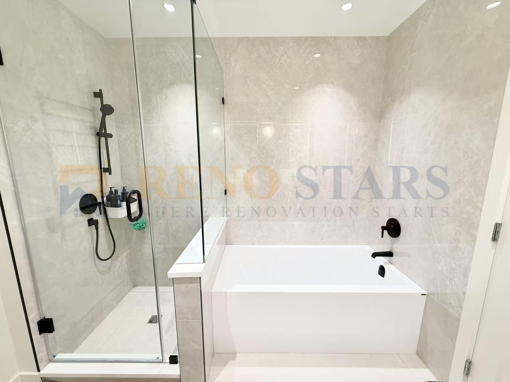 Modern bathroom featuring a glass shower, freestanding tub, and sleek black fixtures.